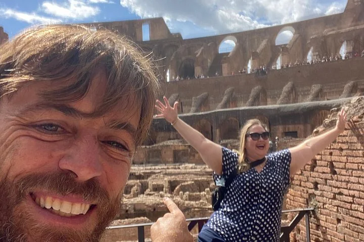 Visitors posing beside the Colosseum’s inner tiers