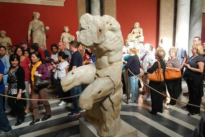 Visitors viewing classical sculpture in the Vatican Museums