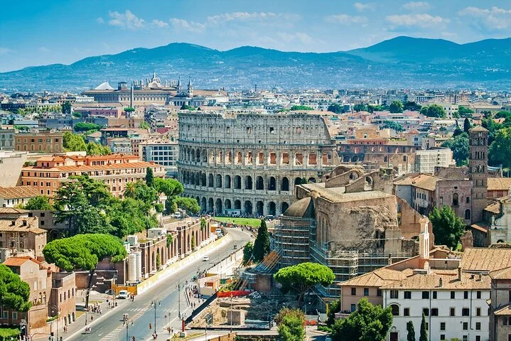 A broad panorama of Rome with the Colosseum