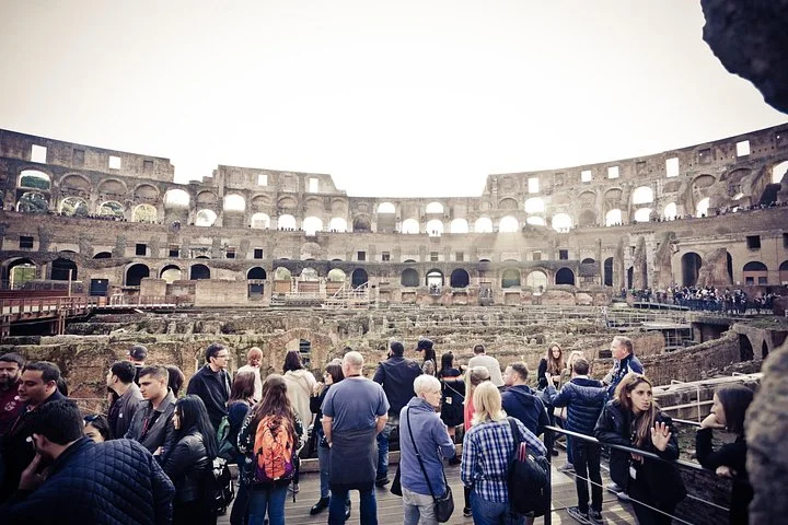 Visitors at a railing inside the Colosseum