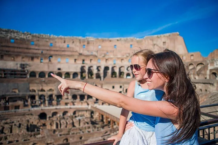 A parent and child pointing across the Colosseum