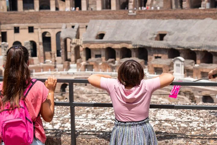 Children looking over a Colosseum viewing railing