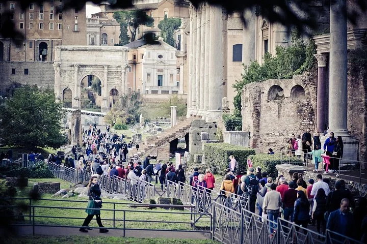 Visitors walking among Roman Forum temples