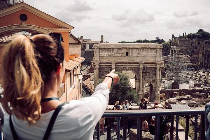 A visitor pointing across the Roman Forum