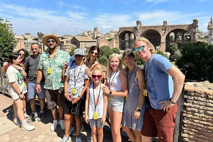 Families with Roman Forum basilica ruins behind