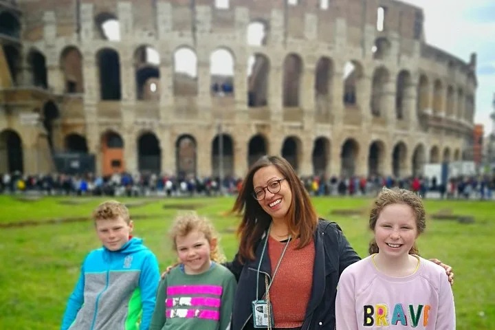A guide and children outside the Colosseum