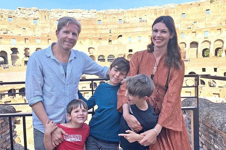 A family at the Colosseum viewing railing