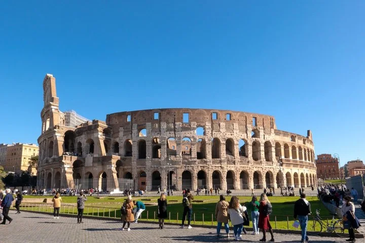 The Colosseum exterior above a green lawn