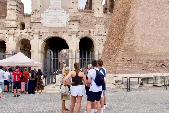 Visitors at an exterior Colosseum entrance