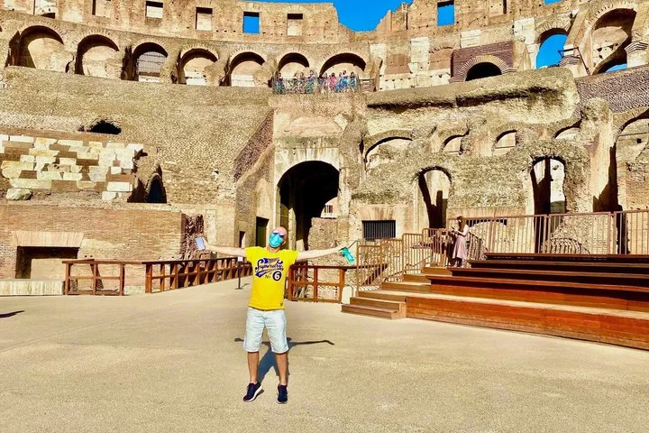 A child jumping on the Colosseum arena floor