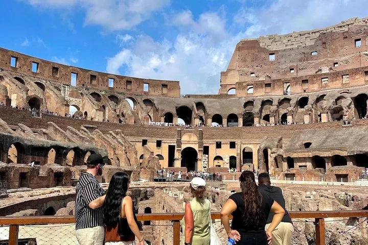 Visitors looking across the Colosseum from the arena