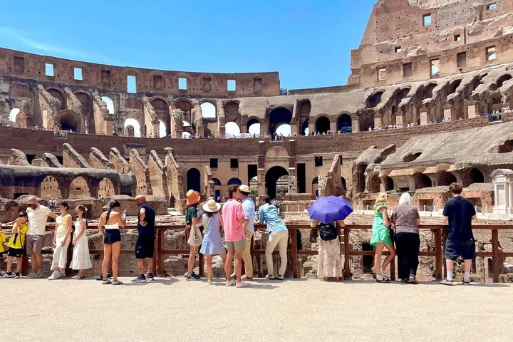 Visitors look across the amphitheatre from the Colosseum arena platform.