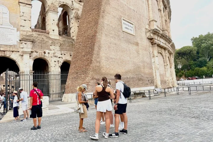 Visitors beside an outer Colosseum entrance