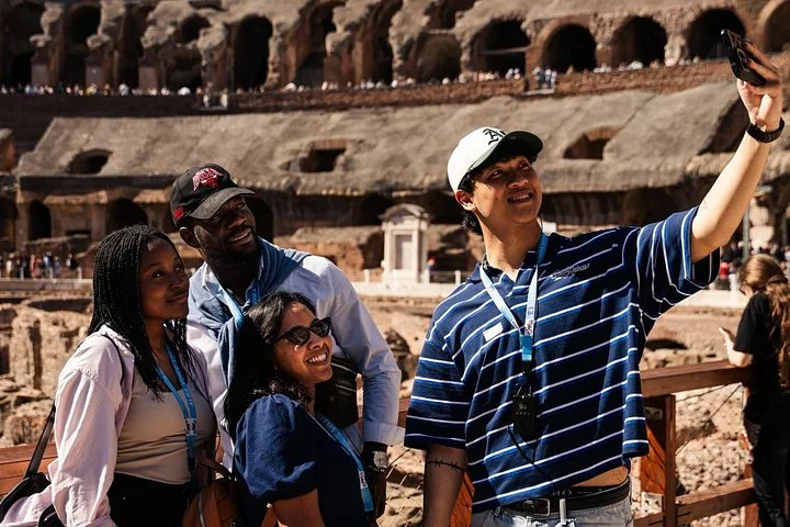 Visitors taking a selfie on the Colosseum arena