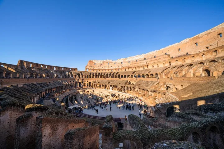 Warm light across the Colosseum interior