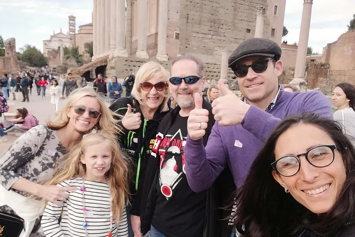 Visitors beside the Temple of Antoninus and Faustina