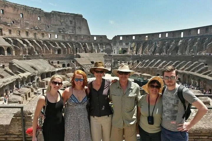 Visitors at a Colosseum interior viewing railing