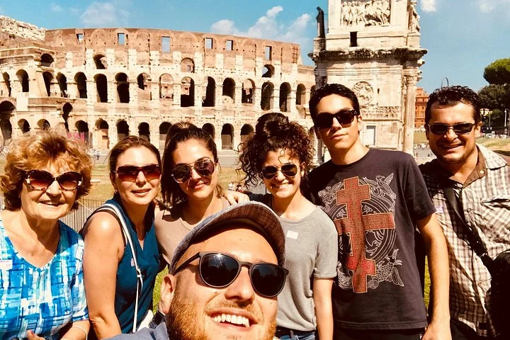 A group with the Colosseum and Arch of Constantine behind
