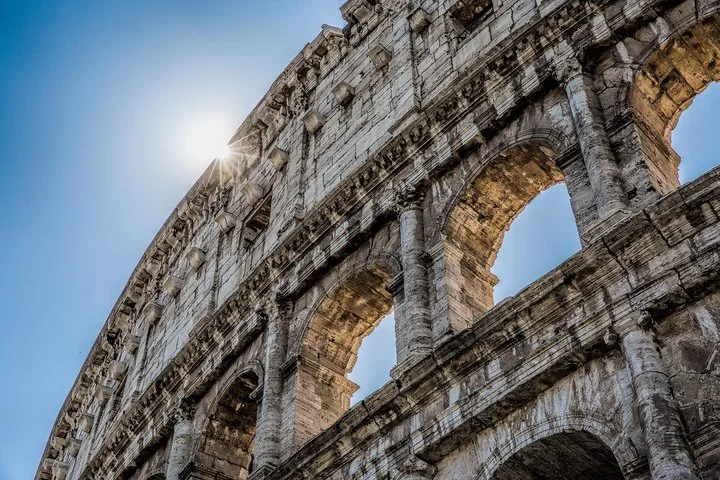 Sunlight over the Colosseum’s exterior arches