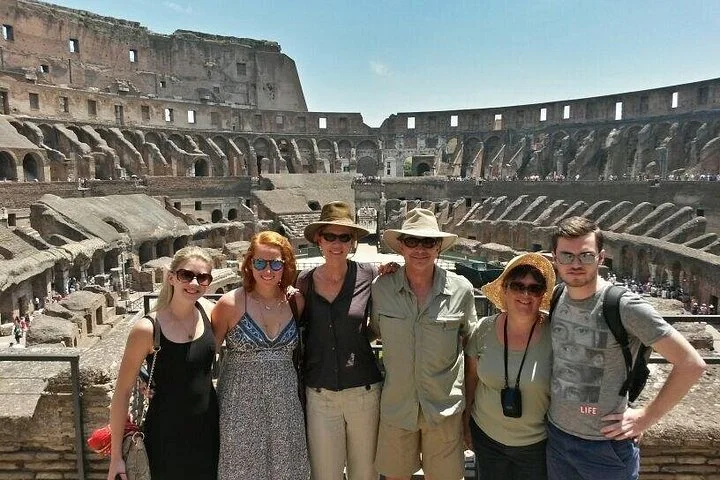 Visitors at a Colosseum interior viewing railing