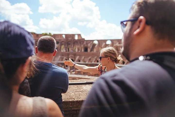 A guide explaining the Colosseum to visitors