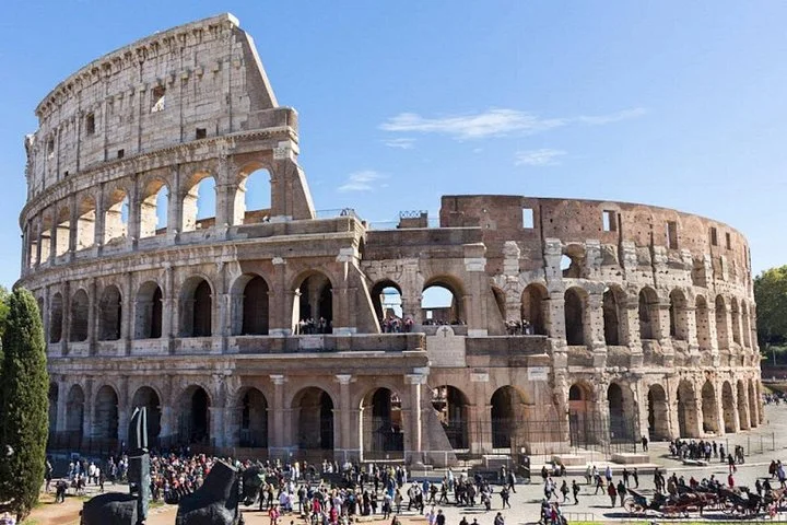 The Colosseum exterior beneath a clear blue sky