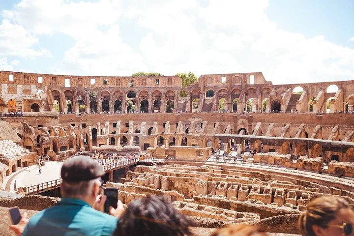 Visitors looking across the Colosseum interior