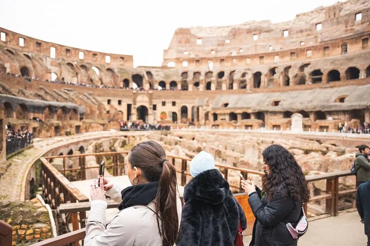 Visitors photographing the Colosseum interior