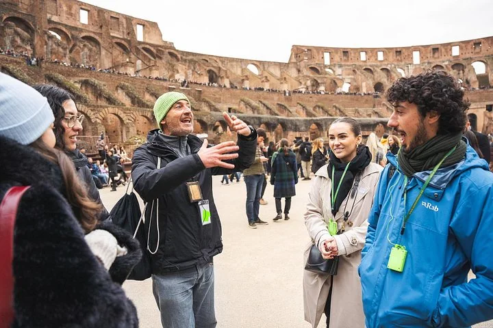 A guide speaking with visitors on the Colosseum arena
