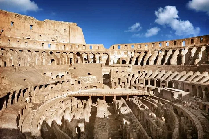 Colosseum tiers and hypogeum under a blue sky