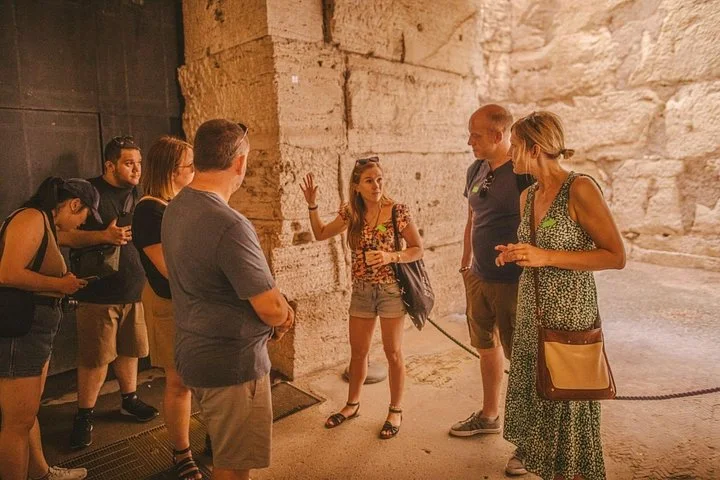 A guide explaining the Colosseum’s stone interior