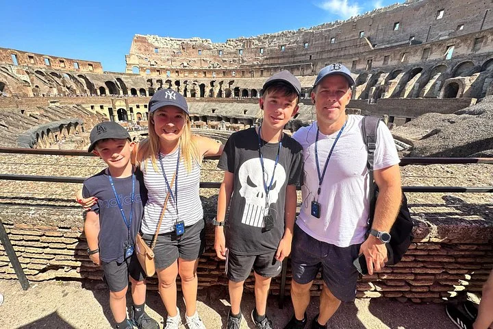 A family posing by a Colosseum railing