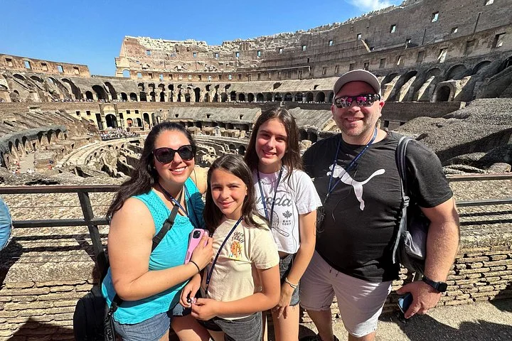 A family posing inside the Colosseum