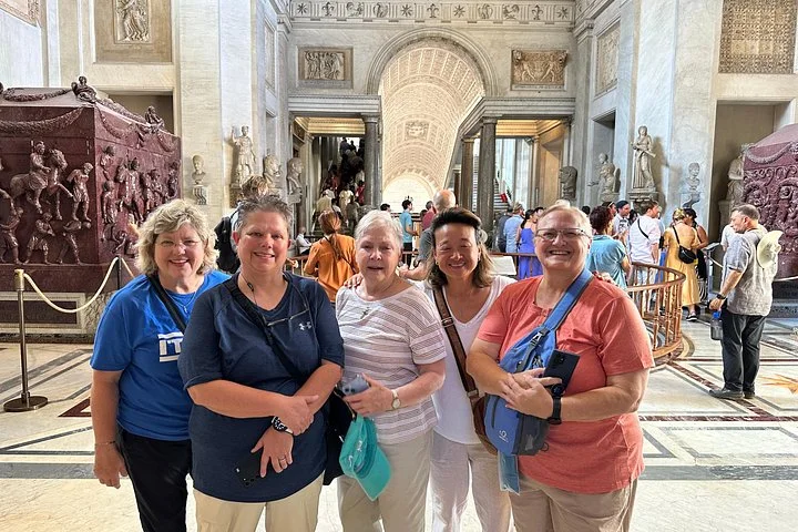 Visitors in a Vatican Museums sculpture gallery