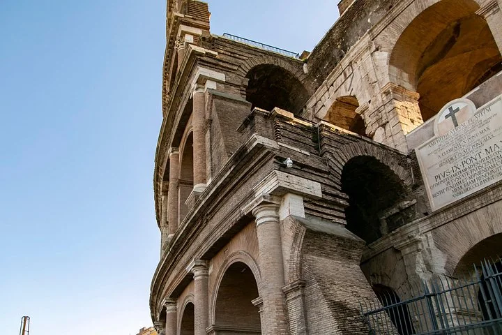 Stone arches at the edge of the Colosseum facade