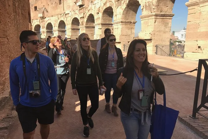 Visitors walking through a Colosseum upper arcade