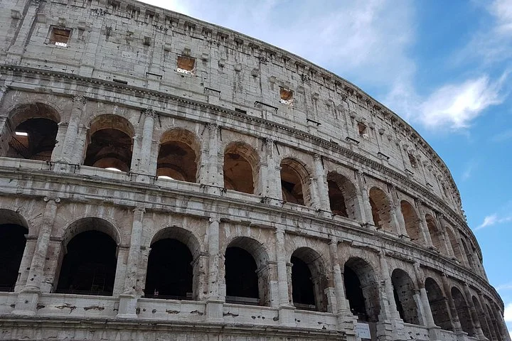 The Colosseum facade under a blue sky