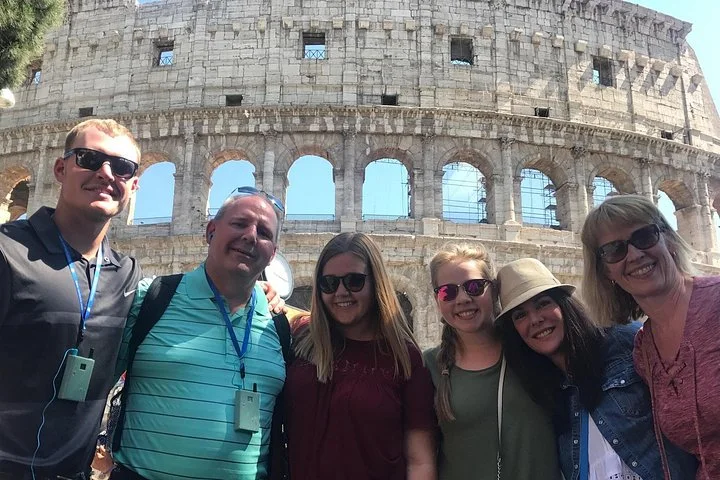 Visitors posing outside the Colosseum
