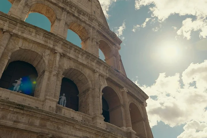 Sunlight beside the Colosseum’s exterior arches