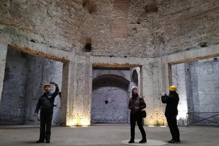 Visitors beneath the vaulted chambers of Domus Aurea