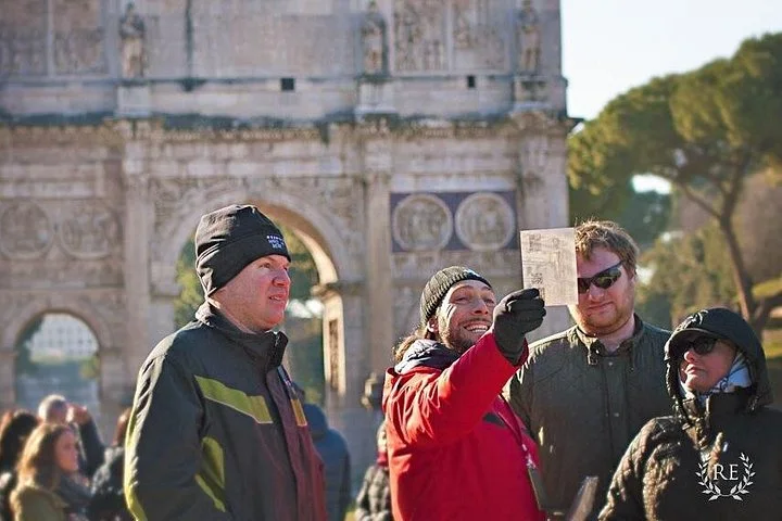 A guide speaking beside the Arch of Constantine