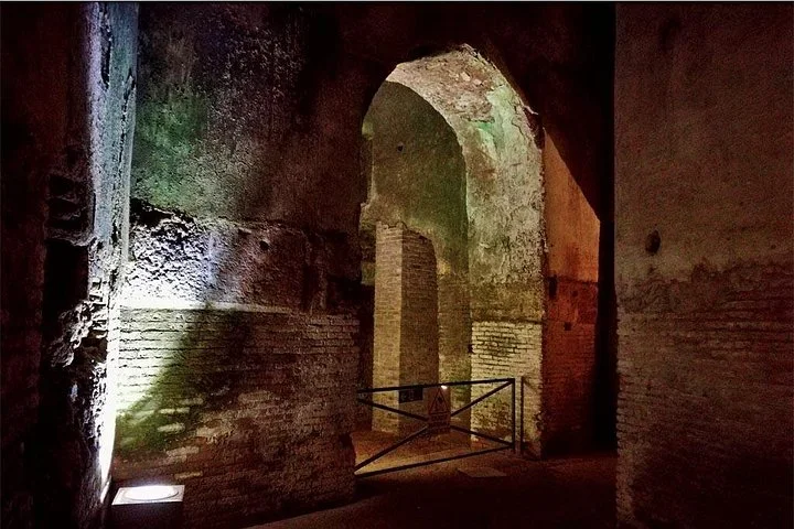 An illuminated archaeological archway in Domus Aurea
