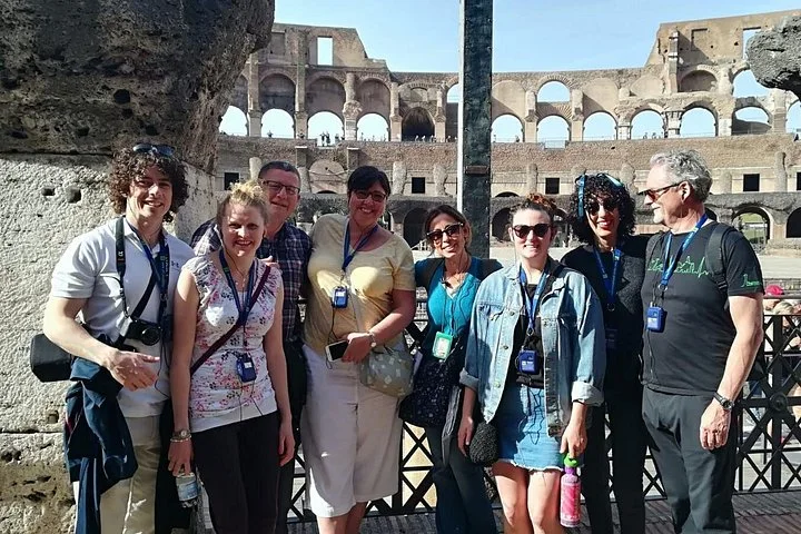 Visitors beneath a Colosseum arch