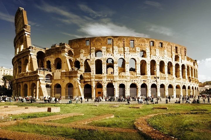 The Colosseum exterior above a green lawn