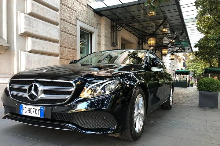 A private-tour car outside a Rome hotel