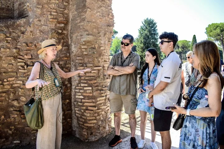 A guide speaking beside ancient brick ruins