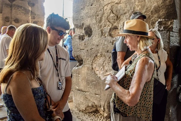 A guide explaining stonework in a Colosseum arcade