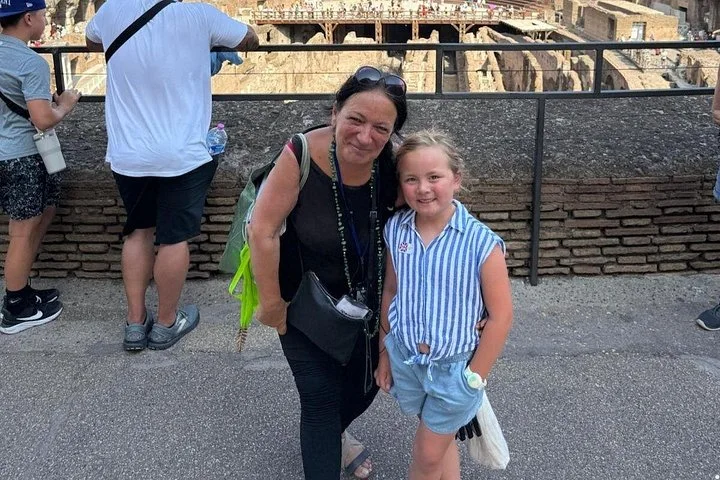 Two visitors at a Colosseum interior railing