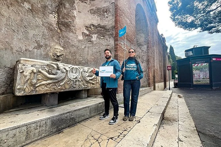 Guides beside an ancient relief on the Forum route
